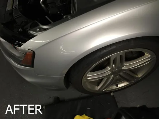 The same silver car fender restored to a smooth finish after repair